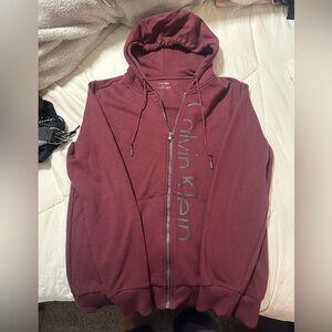 XS Calvin Klein burgundy with black letter logo zip up jacket with hood.